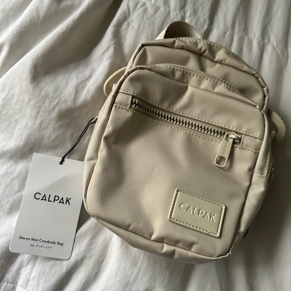 Calpak travel crossbody new with tag. Never used. Beige.